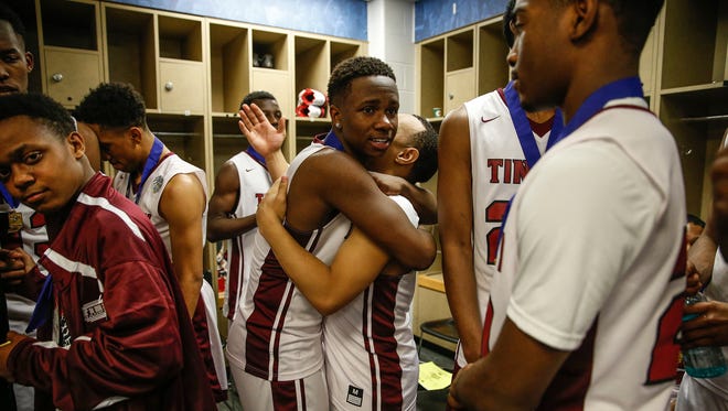 Tindley Tigers’ Sincere McMahon (4) hugs teammate Tindley Tigers’ Joe Johnson (0) after their IHSAA Class A state championship game 51-49 win over the Lafayette Central Catholic Knights at Bankers Life Fieldhouse in Indianapolis on Saturday, March 25, 2017. 