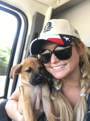 Miranda Lambert cuddles a puppy MuttNation Foundation pulled from a Houston-area shelter.