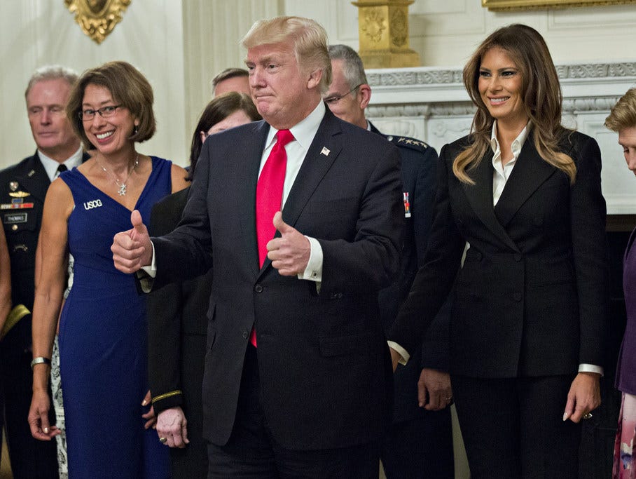 President Trump and first lady Melania Trump pose for pictures with senior military leaders and spouses after a briefing in the State Dining Room of the White House Oct. 5, 2017 in Washington.