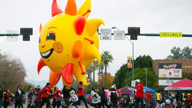 The "Spirit" balloon, the Fiesta Bowl mascot is spun around on the parade route during the 46th Fiesta Bowl Parade in Phoenix on Saturday, December 31, 2016.