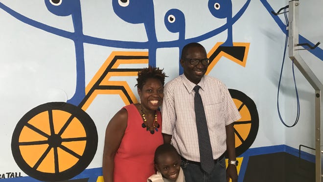 Artist Papa Tall, his wife, Hill, and son, Jabari, attend the unveiling of his mural on Aug. 3, 2017, at Bloomfield's bike depot.