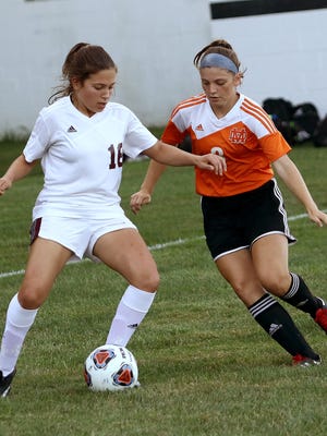 Woodbridge's Kiley Dugan, left, and Marlington's Laney Hess during action at Marlington last season.