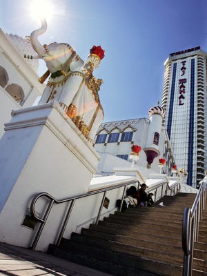 In a 2007 photo, people rest in the shade near an elephant statue at the Trump Taj Mahal in Atlantic City. After the casino went into bankruptcy the year after it opened, Michael MacLeod, whose studio made giant elephant statues and faux boulders for the complex, recalls, 'We got next to nothing … I took a big hit.'