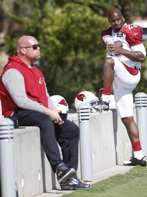 Cardinals GM Steve Keim watches practice as running back Adrian Peterson (23) warms up during practice at the Cardinals Training Facility in Tempe, Ariz. on November 2, 2017.