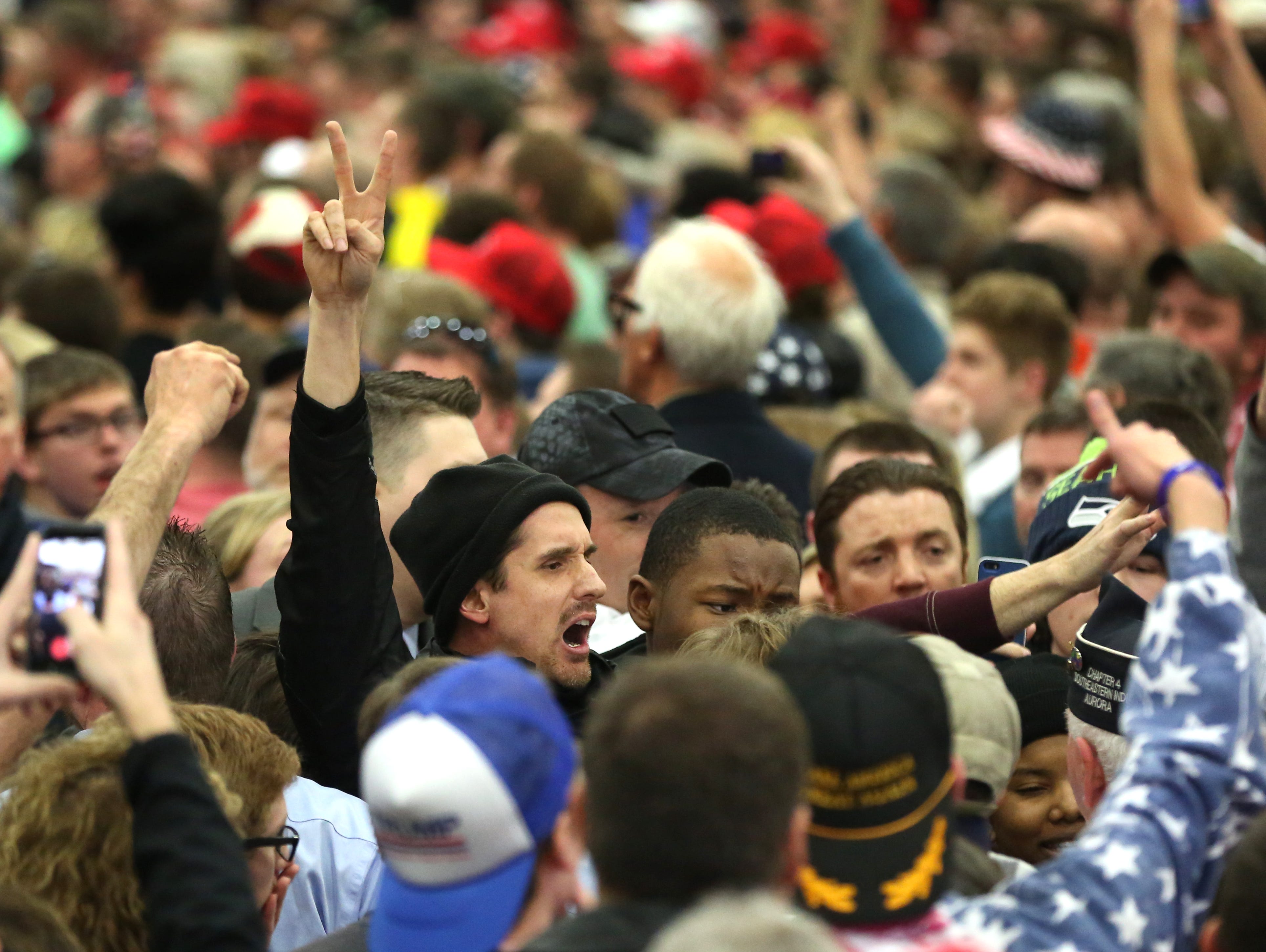 Protesters are escorted through the crowd inside the Donald Trump rally in Louisville.nMar. 1, 2016