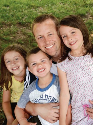 Chuck Miller with his children, from left, Addison, Solomon and Olivia.