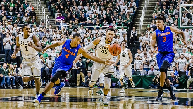 KeVaughn Allen ,4, of Florida steals the ball from Denzel Valentine ,45, of MSU late in the 1st half of their game Saturday December 12, 2015 in East Lansing.  KEVIN W. FOWLER PHOTO