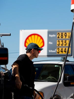 
Kevin Greer fills the tank at Shell Gas & Shop on Hancock Bridge Parkway in Cape Coral  on Monday. Gas prices are inching lower with some stations showing prices below the $3.00 mark.

