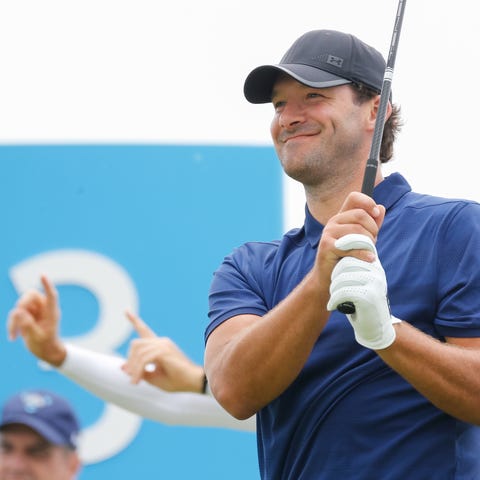 Tony Romo smiles before teeing off on the third...