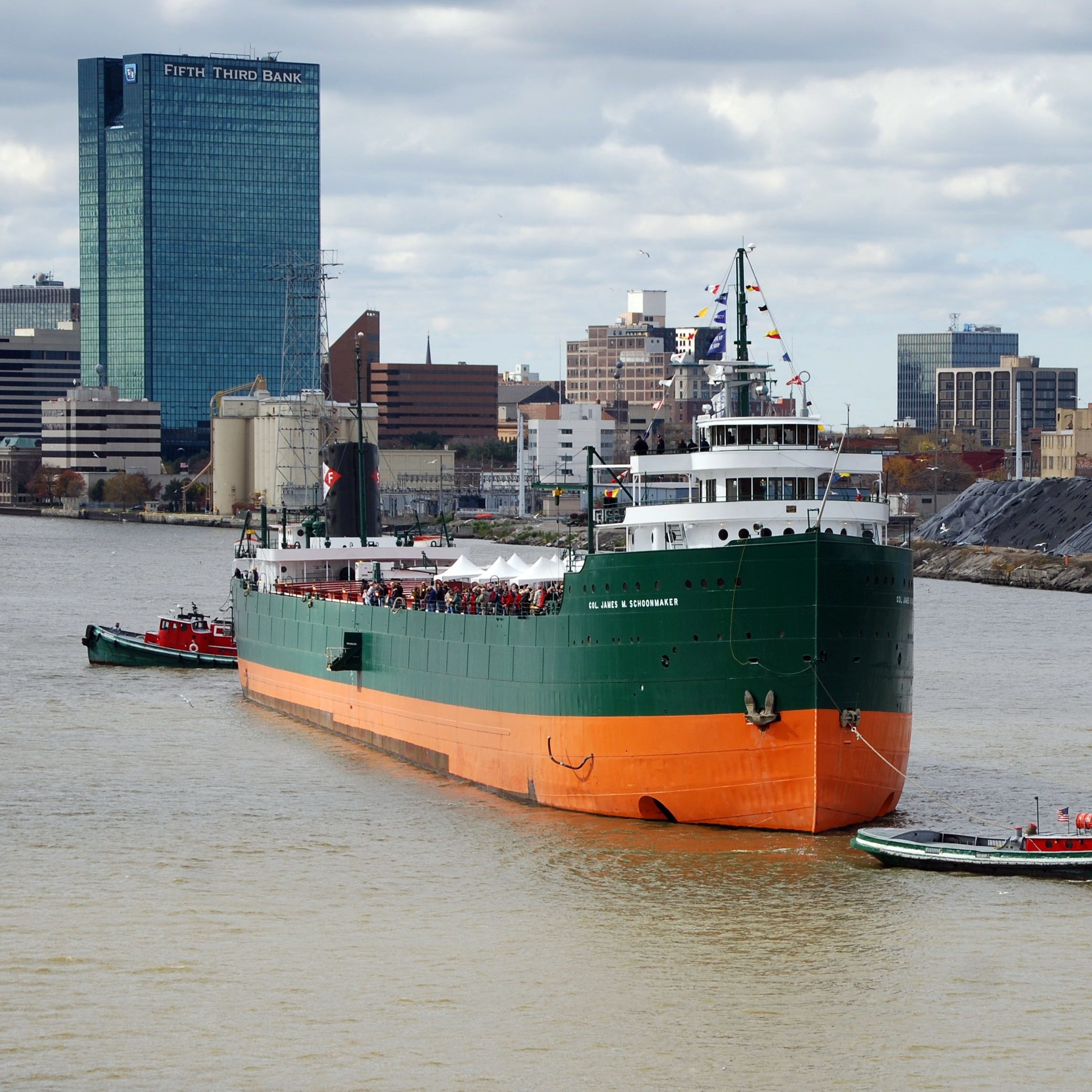 On Oct. 27, 2012, the historic Great Lakes freighter S.S. Col. James M. Schoonmaker is tugged on the Maumee River past the Toledo skyline to its new mooring at the National Museum of the Great Lakes.