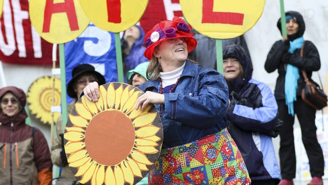 The Raging Grannies perform a song and dance routine at a rally for a Healthy Climate and Clean Energy Jobs on the steps of the Capitol on Wednesday, Feb. 3, 2016.