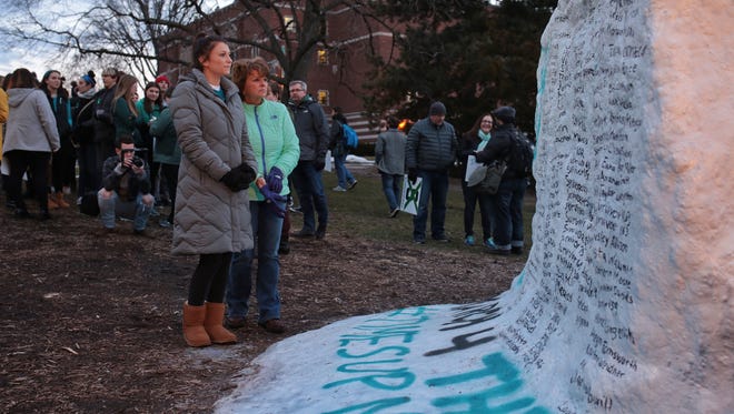 Christy Lemke 
(left) stands with her daughter survivor Lindsey Lemke while looking over names of sexual assault victims of Larry Nassar as people gather at The Rock on Friday January 26, 2018 on the Michigan State University campus in East Lansing to speak out against sexual assault following the Larry Nassar case. Lemke was assaulted and confronted Nassar during his sentencing hearing.