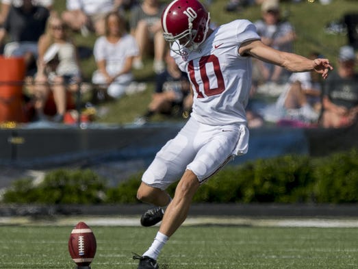Alabama kicker JK Scott (10) kicks off at Vanderbilt