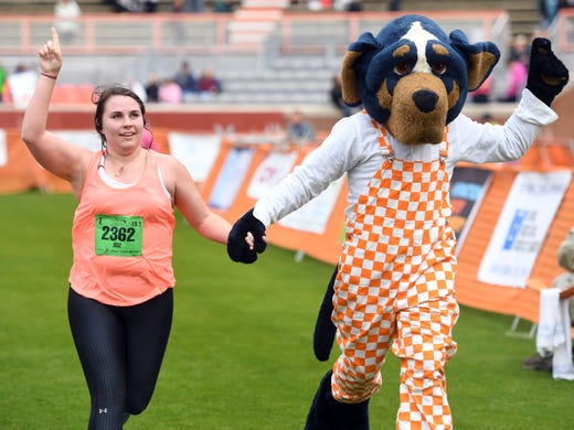 Suzi Hall crossed the finish line with Tennessee mascot