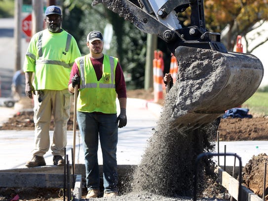 Workers add a sidewalk to Franklin Avenue between Manchester