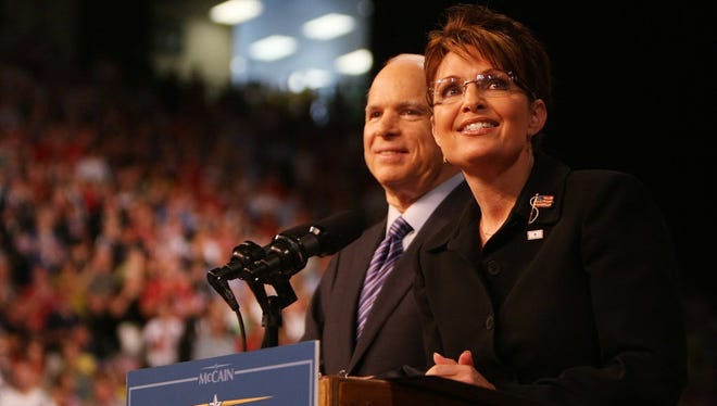 Sen. John McCain stands with then-Alaska Gov. Sarah Palin onstage at a campaign rally August 29, 2008 in Dayton, Ohio. McCain announced Palin as his vice presidential running mate at the rally.