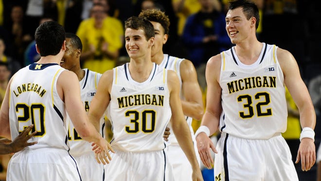 Michigan teammates celebrate after freshman Austin Hatch (30) made a free throw late in Monday's exhibition victory over Wayne State at Crisler Center in Ann Arbor.