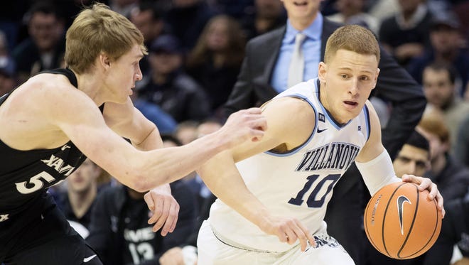 Villanova Wildcats guard Donte DiVincenzo (10) dribbles against Xavier Musketeers guard J.P. Macura (55) during the first half at Wells Fargo Center.