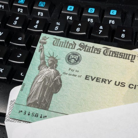 Federal government-issued check lying on a compute