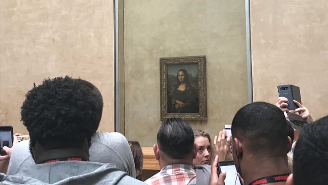 Michigan players look at the Mona Lisa at the Louvre on April 28, 2018 in Paris.