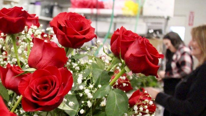 Floral designers assemble bouquets on Feb. 10 at Don's Flowers & Gifts in Zeeland in anticipation of Valentine's Day.