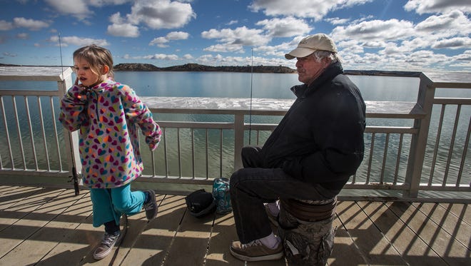 Elizabeth Howerton and her grandfather Curtis Howerton enjoy a day fishing on Monday at Farmington Lake.