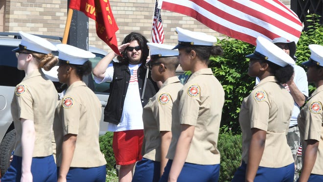 Mehdi Asaad salutes as the Marines go by during the 93rd Memorial Day Parade and Remembrance Service in Dearborn on Monday. The parade’s theme was “women in the military” to honor the contributions and advancements of women serving in the armed forces.