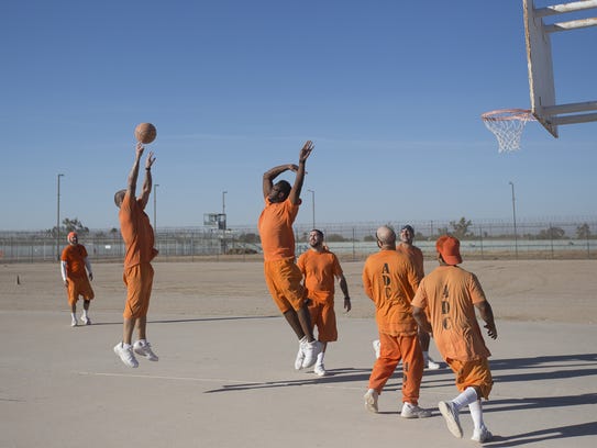 Death-row inmates play a game of basketball at the