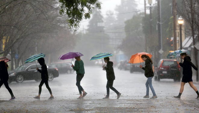 Students from St. John the Baptist Catholic school in Healdsburg, Calif., walk through a deluge as a powerful storm descends on the region Feb. 6, 2015.