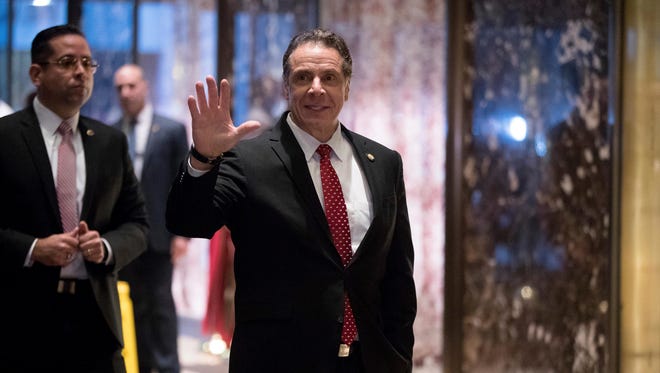 New York Gov. Andrew Cuomo waves as he arrives for a meeting with President-elect Donald Trump at Trump Tower in New York, Wednesday, Jan. 18, 2017.
