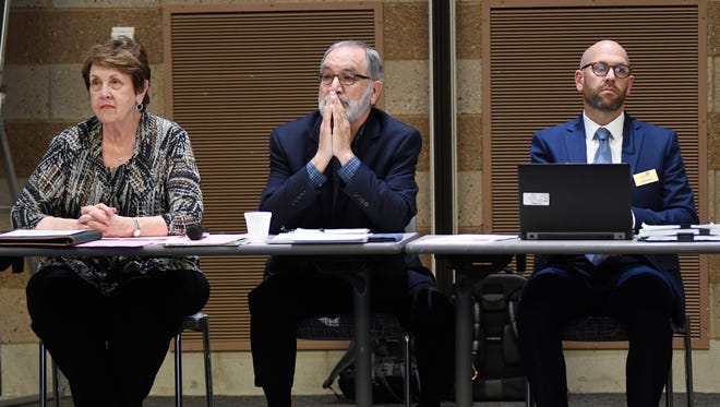 From left, Michigan Department of Education senior executive policy advisor Linda Forward, social studies consultant Jim Cameron, and social studies consultant for assessment Scott Koenig list to audience comments last year.