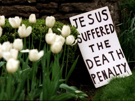 A death penalty protester sign rest on the wall in