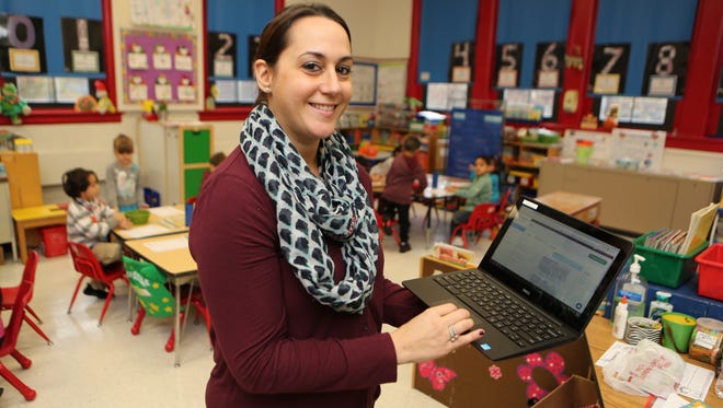Adrienne Capocci, a kindergarten teacher at the Dixson Primary School in Elmsford, uses the web to send a message from the TalkingPoints program.