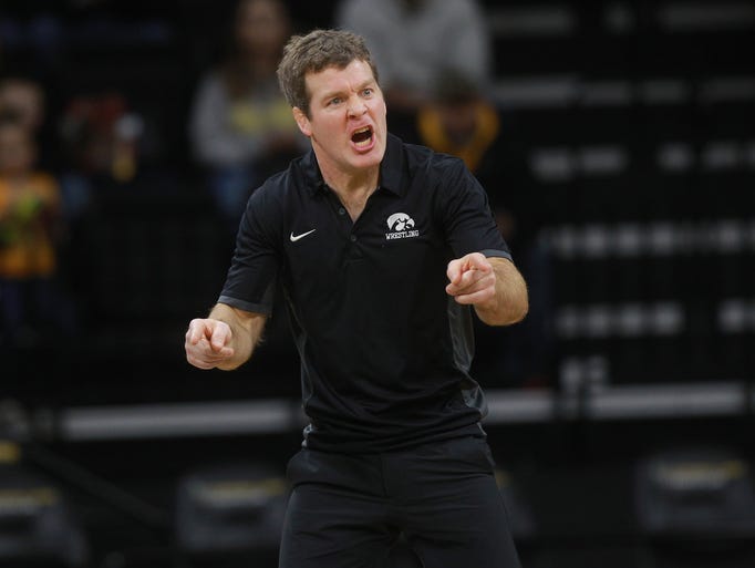 Iowa head coach Tom Brands calls to Paul Glynn as he