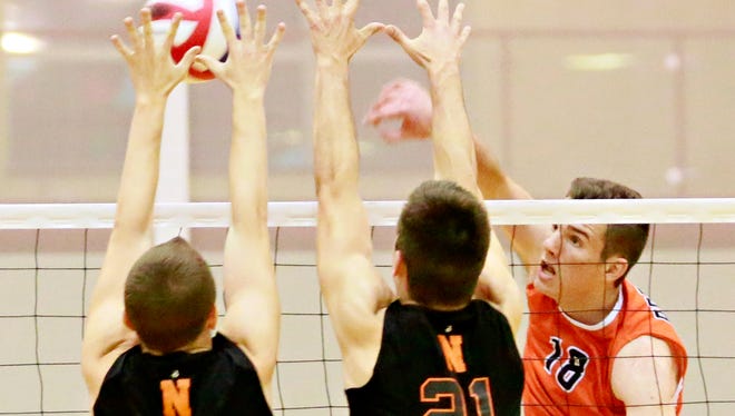 Central York's Cole Johnson, right, sends the ball over the net while Northeastern's Nate Eyster, center, and Cole Brillhart defend during volleyball action at Central York High School in Springettsbury Township, Thursday, May 11, 2017. Central York would win the match 3-0. Dawn J. Sagert photo