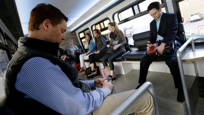 Several commuters ride a Leap bus ride in San Francisco.