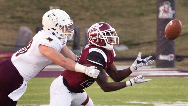 New Mexico State cornerback Shamad Lomax gets in front of Texas State receiver Hutch White for one of his two interceptions Saturday afternoon at Aggie Memorial Stadium.