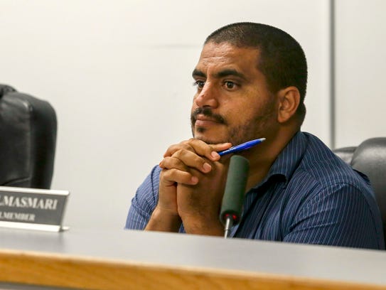 Councilman Saad Almasmari listens to a comunity member