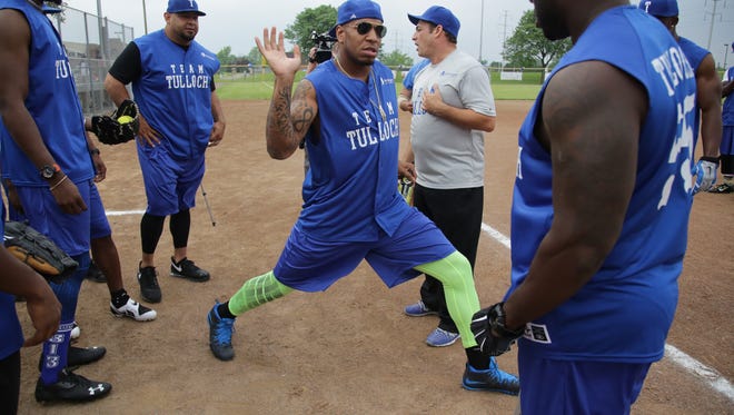 Lions TE Eric Ebron jokes around with his team during the Lions annual charity softball game hosted by Stephen Tulloch and Golden Tate at King Boring Field in Dearborn on Friday. All proceeds from the festivities will support the Stephen Tulloch Foundation and Operation 55, which supplies 55 schools across Detroit with school supplies, technology and equipment for everyday learning to help the students to excel in the classroom.