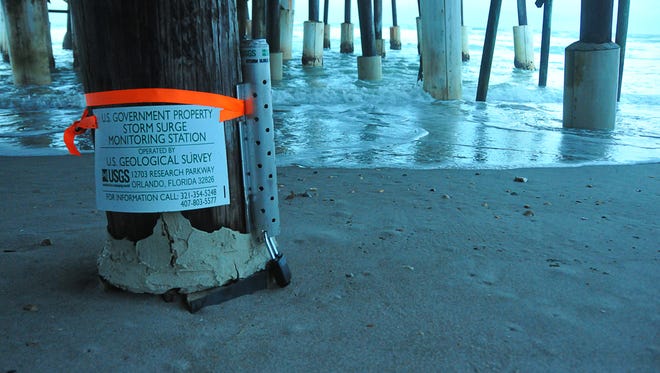 A storm surge monitor station was strapped to a piling of the Cocoa Beach Pier.