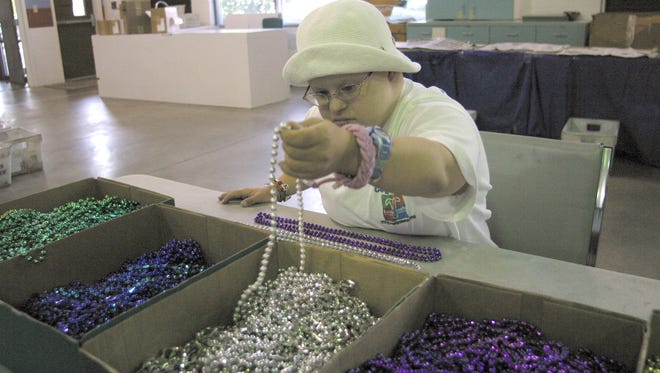 Beth Marshall sorts used Mardi Gras beads at ARC Gateway Inc., a nonprofit provider of services for people with disabilities.