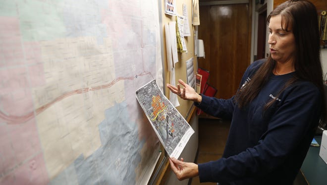 Shelléy Perkins points out coverage areas for the Engine Crew 6 and the people they serve at Phoenix Fire Station 6 on Jan. 6, 2018, in Phoenix, Ariz.