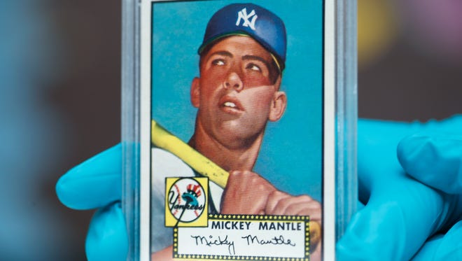 The "Holy Grail" of baseball cards, a 1952 Topps Mickey Mantle that is valued at more than $10 million, is put on display as part of baseball memorabilia exhibit at the Colorado History Museum Monday, July 16, 2018, in Denver. The pristine card, one of three known to still be in existence, is owned by Denver lawyer Marshall Fogell.