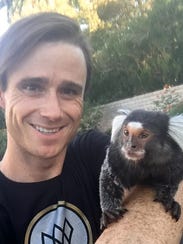 Jason Ellis, 30, of Las Vegas, holds Gizmo, a marmoset