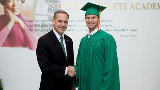 MSU announced on Wednesday the establishment of the Mike Sadler Legacy Football Scholarship. Pictured are Coach Mark Dantonio and Sadler, who was killed over the weekend in a car crash.