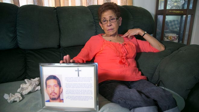 Doris Y. Concepcion holds a photograph of her son, Joseph A. Quinata, at her home in Prescott on May 26, 2016. Concepcion alleges that her son was molested by Archbishop Anthony Apuron when he was an altar boy in Guam some 40 years ago. Quinata told her about being molested by Apuron just before he went into surgery for intestinal perforation in 2005. He did not survive the surgery. Quinata was 38 when he died.