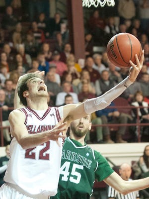 Bellarmine University forward Adam Eberhard uses a reverse layup to keep the ball from University of Wisconsin-Parkside center Goran Zagorac in the NCAA Division II Midwest regional opener in Knights Hall.11 March 2017