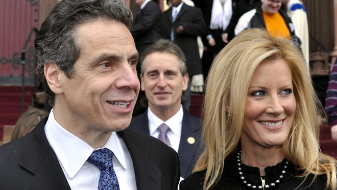 This  Jan. 2, 2011 file photo shows New York Gov. Andrew Cuomo, left, with his girlfriend, Sandra Lee, and Lt. Gov. Robert Duffy, center, in 2011.