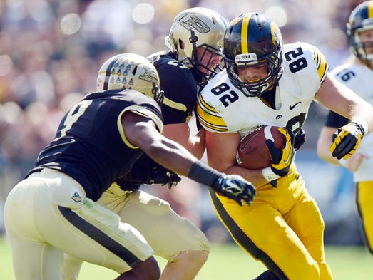 Sep 27, 2014; West Lafayette, IN, USA; Iowa Hawkeyes wide receiver Matt Vandeberg (89) is tackled by Purdue Boilermakers linebacker Jimmy Herman (29) and defensive back Anthony Brown (9) during the first half of the game at Ross Ade Stadium. Mandatory Credit: Marc Lebryk-USA TODAY Sports