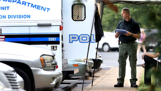 Murfreesboro Police Department personnel investigate a homicide at The Cove at Center Point apartments in Murfreesboro Friday, Aug. 7, 2015.